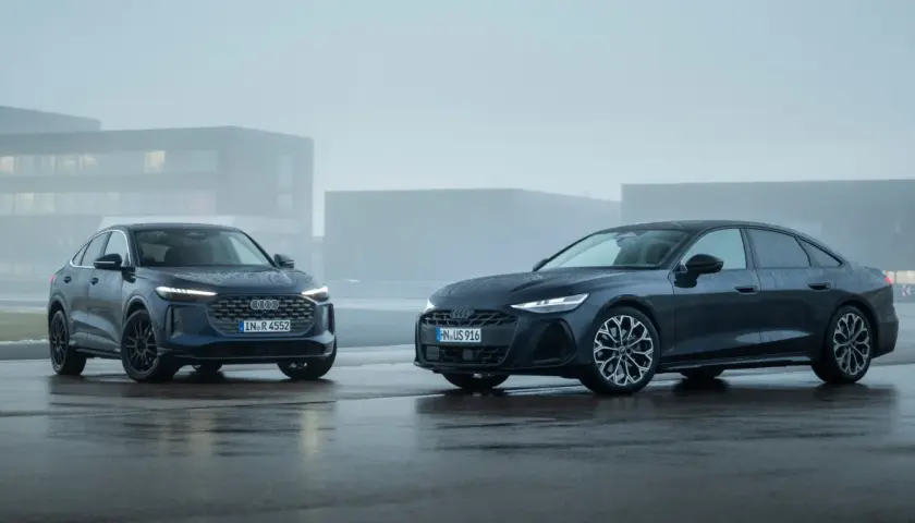 Dwa Audi, SUV i sedan, błyszczą na mokrym asfalcie. Jeden z nich to potężne 3.0 TDI, gotowe na każdą drogę.