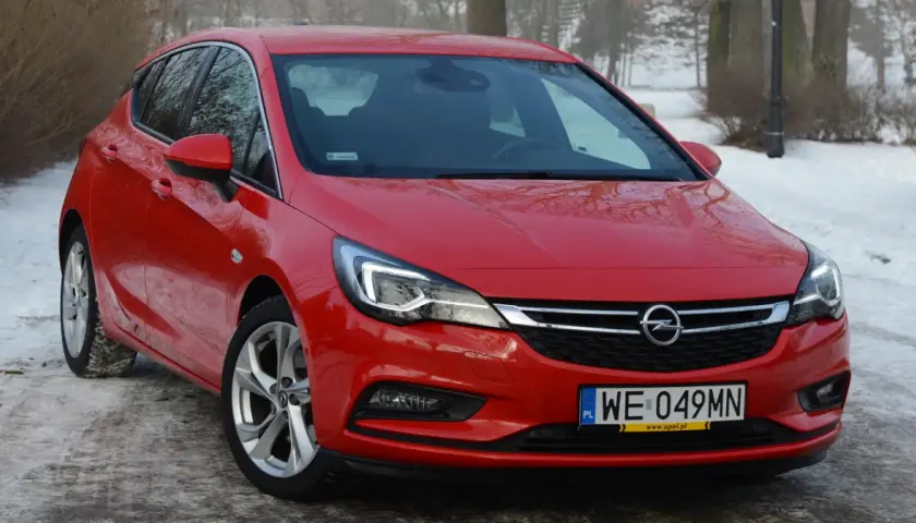 Czerwona Astra K 1.6 CDTI na tle zimowego krajobrazu.